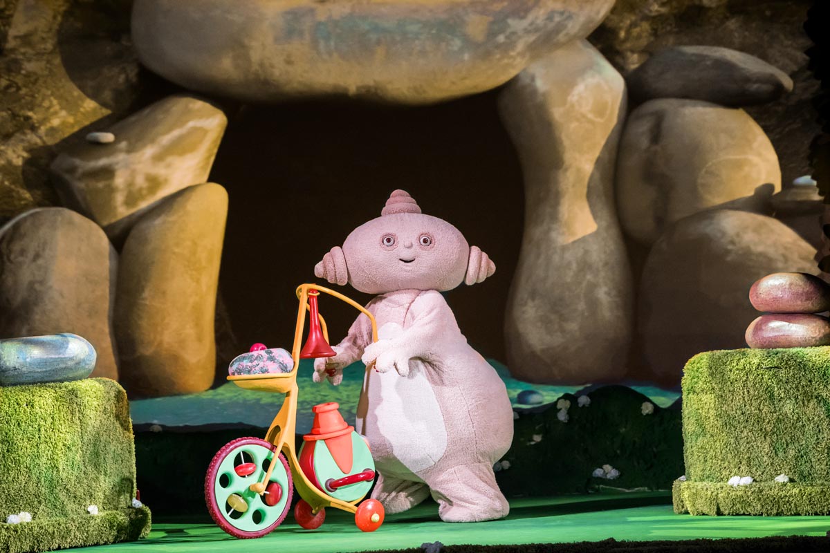 Makka Pakka rides his scooter Og-Pog in front of his stone cave on the In The Night Garden Live Stage.