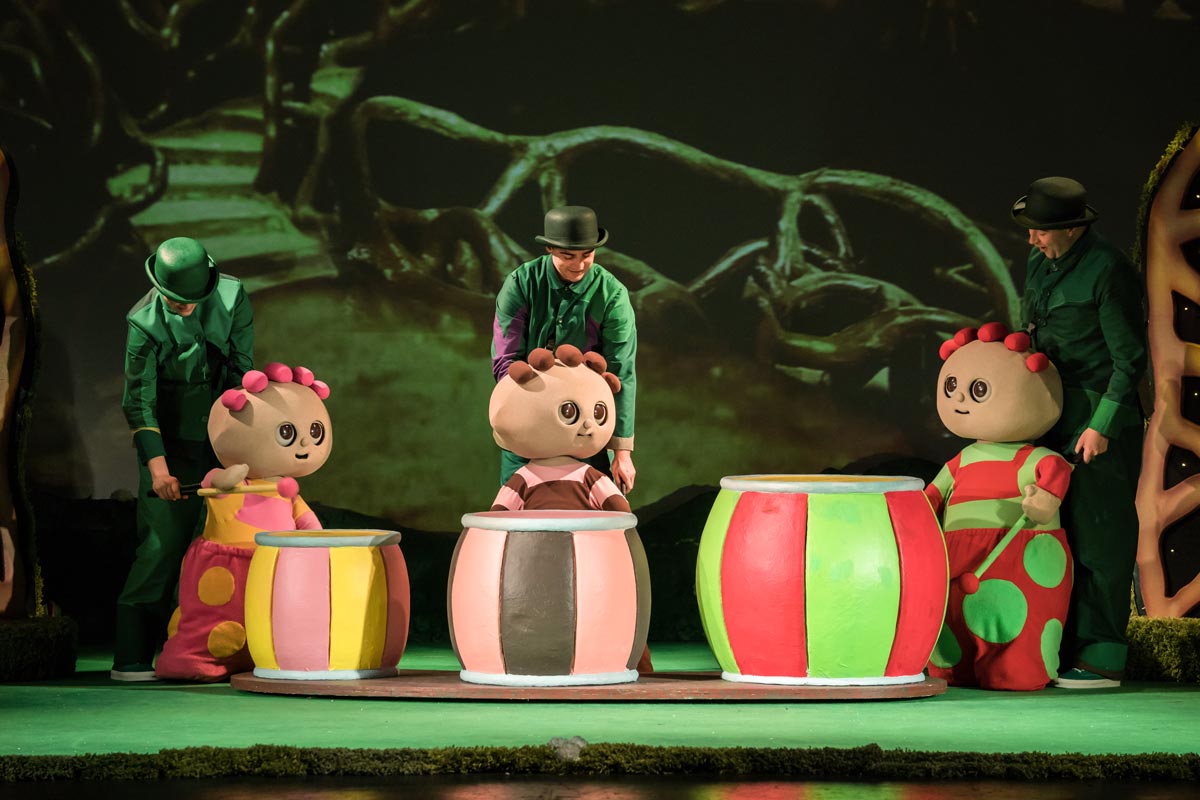The three Tomliboos play their drums on the In The Night Garden Live Stage. They are controlled by puppeteers in smart green outfits.